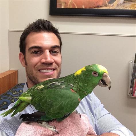 taking a selfie with a parrot the hot veterinarian popsugar love