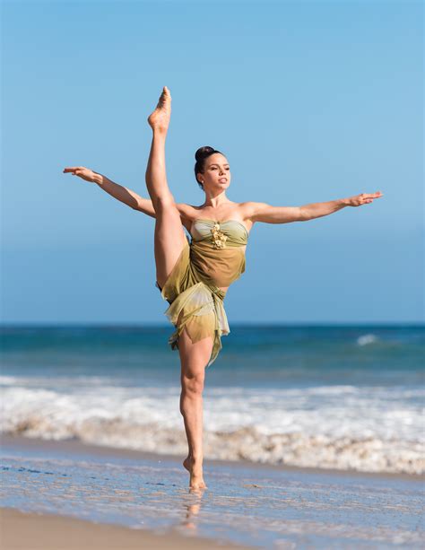 Woman Dance Jumping In Mid Air Near Body Of Water During