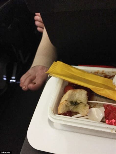 qantas passenger pokes her foot between the seats daily mail online