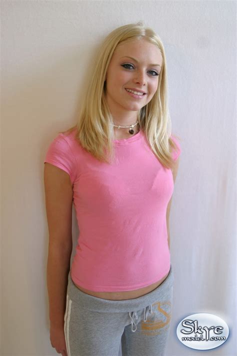 super cute skye poses for pictures in a tight pink shirt and grey sweat capris
