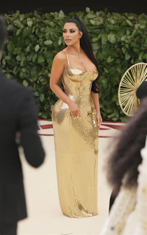 kim kardashian wears shiny gold dress to the met gala kanye skips met