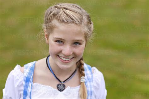 germany luneburger heide portrait of smiling blond girl wearing