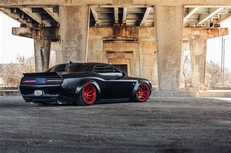 blacked   stanced dodge challenger srt benefits  custom red wheels dodge challenger