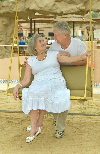 Premium Photo Portrait Of Beautiful Elderly Couple On Swing