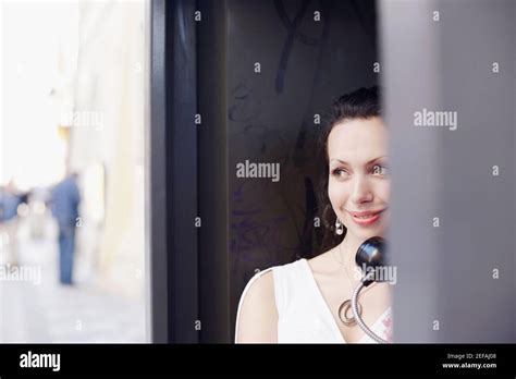 young woman   telephone booth stock photo alamy