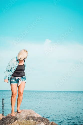 tanned blonde woman walking at summer beach mature female in denim