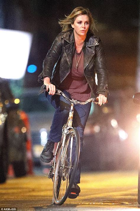charlize theron shows fuller figure while riding a bike on