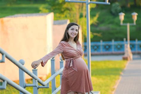 Pregnant Girl Posing On The Stairs Brunette In A Velor Dress Stock