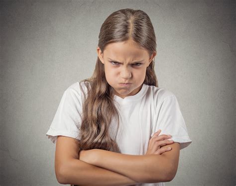 headshot angry girl    isolated  grey background school mum