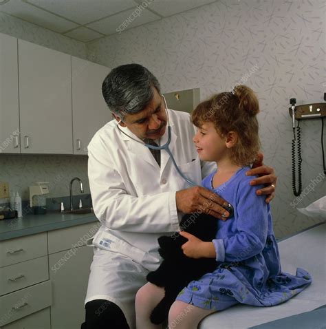 Doctor Uses Stethoscope To Listen To Girl S Chest Stock Image M825