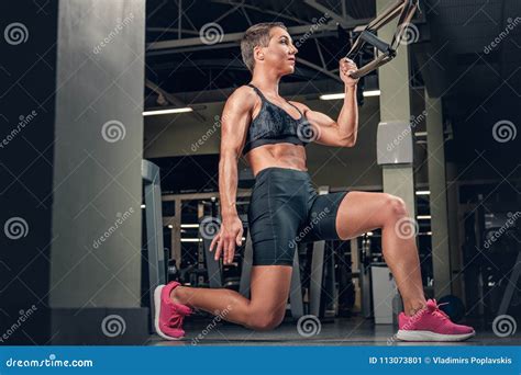 Female Doing Workouts With Trx Suspension Strips In A Gym Club Stock