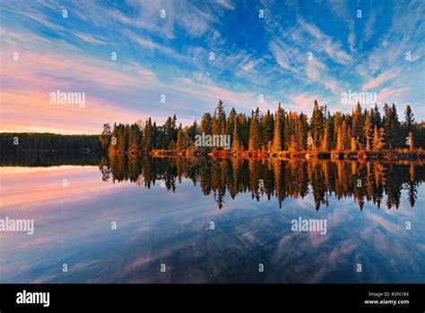 canada ontario kenora reflection at sunset in graphic lake stock