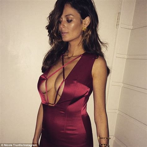 nicole trunfio busts out of very low cut burgundy gown