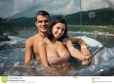 Romantic Couple Enjoying Jacuzzi Outdoors And Taking