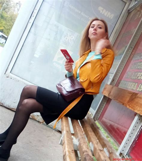 Skinny Tall Girl Sitting In The Bus Stop With Crossed Legs