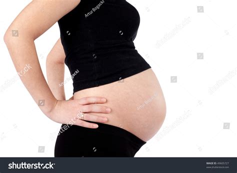 nine month pregnant woman with hands on hips isolated over white