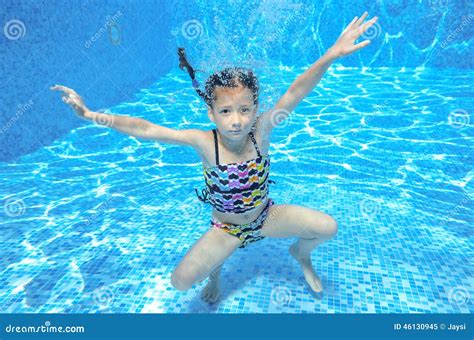 happy active underwater child swims  pool stock photo image