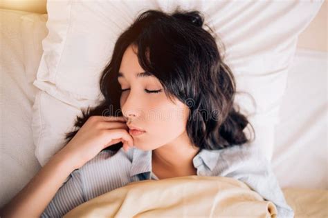 Young Beautiful Woman Sleeping In Bed Relaxing In The Morning Stock