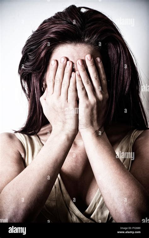 young woman hiding face   hands stock photo alamy