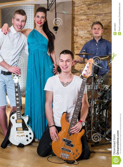 Musical Group Of Three Guys And One Girl In Recording