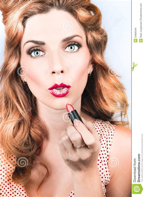 retro beauty pin up girl applying lipstick makeup stock