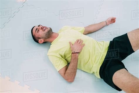 exhausted man lying  floor   stock photo dissolve