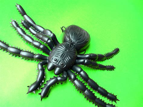 image  black plastic spider toy  green background creepyhalloweenimages
