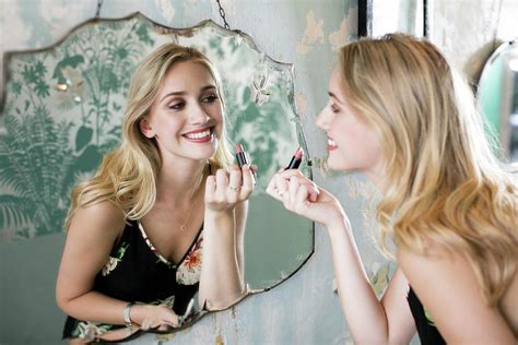 Woman Applying Lipstick In Mirror Photograph By Science Photo Library