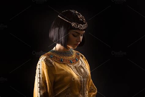 beautiful woman like egyptian queen cleopatra with serius face on black