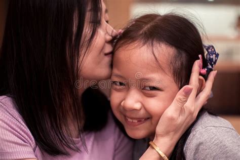 asian daughter smiling with her mother kissing stock image image of