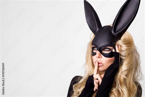 sexy woman with large breasts wearing a black mask easter bunny