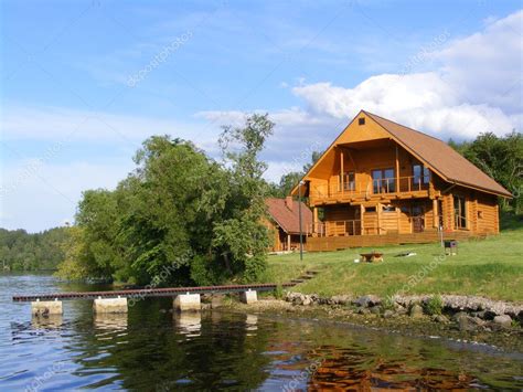 beautiful wooden house   river stock editorial photo