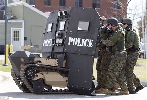 swat bots carrying ballistic shields  remote controlled tank  vehicles   protect