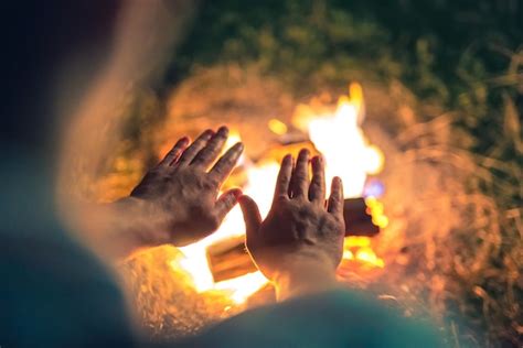 Premium Photo The Man Warming Hands Near The Bonfire Night Time