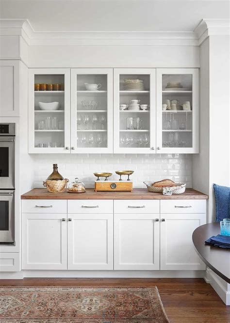 glass front white cabinets butcher block counter modern white kitchen