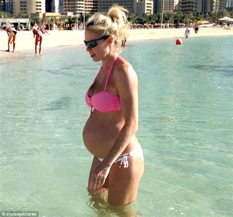 mum to be nell mcandrew looks fabulous in fuchsia as she spends new year s on the beach in dubai
