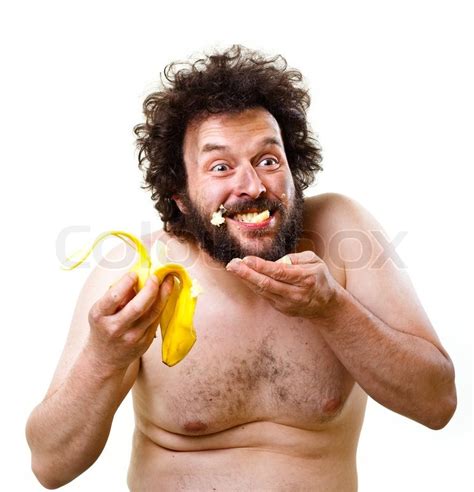 wild undressed man with crazy hair and beard eating a