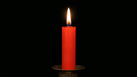 continuous loop   burning red candle   black background stock