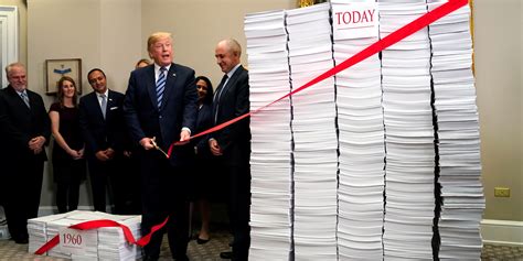 trump stood next to a huge pile of paper to showcase excess regulation