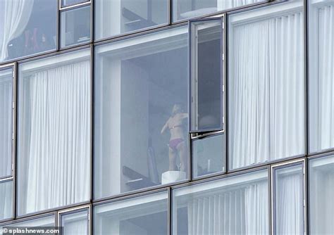 couple are caught cavorting nyc hotel window as in room photographer