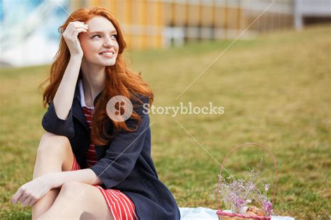 portrait of a smiling happy red head girl having easter picnic with