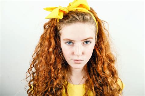 Premium Photo Portrait Of Curly Redhead Girl With A Yellow Bow On Her