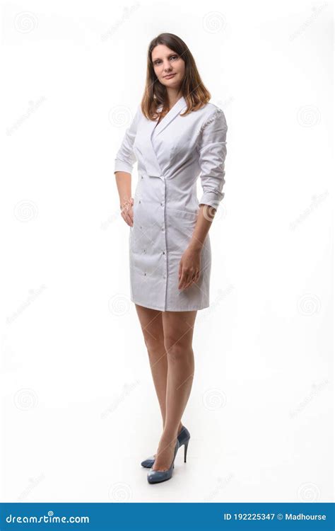 Tall Slender Girl Stands In Full Height In White Uniform In High Heeled