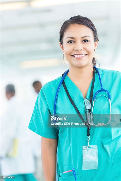 Beautiful Confident Hispanic Nurse Or Doctor Walking Through Hospital