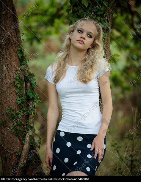 beautiful blond teenage girl outside in the woods