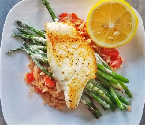 Sea Bass With Tomato Risotto Asparagus And Creamy Lemon Sauce The