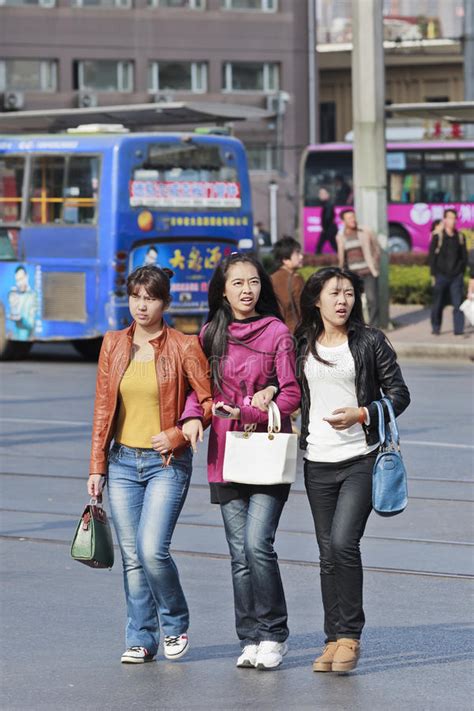 three chinese teenagers on the street editorial photography image of