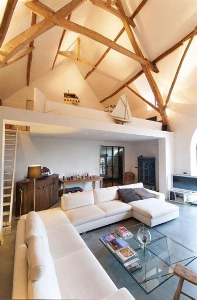 living room filled  white furniture  wooden beams   ceiling    glass