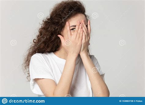 sly girl hiding face  hands peeps  fingers stock photo image  curious gaper