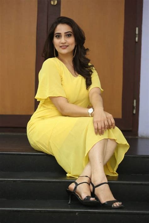 manjusha indian tv anchor photo shoot in yellow dress glamorous